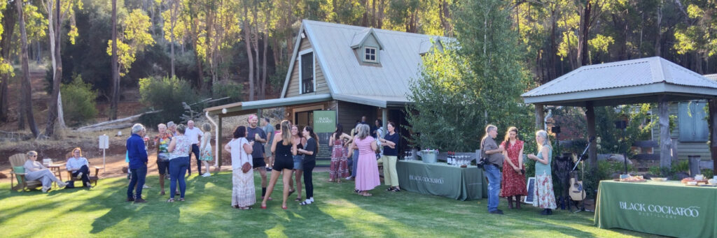 Black Cockatoo Cellar Door party on the lawn as the sun starts to set.